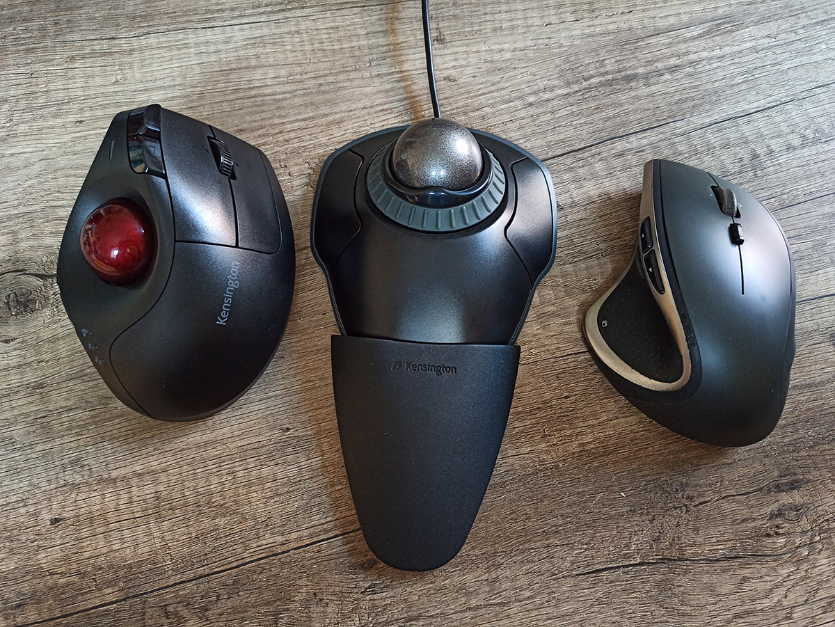 Kensington Pro Fit and Ergo Orbit Trackballs next to Logitech M705 mouse